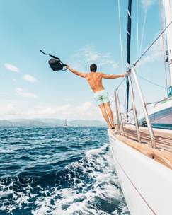 A man holdingblack backpack on a yacht charter