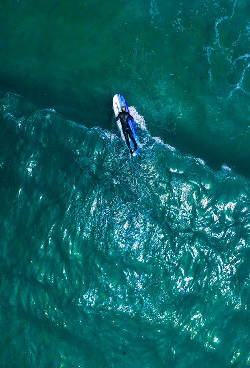 A man floating on a board in the sea.