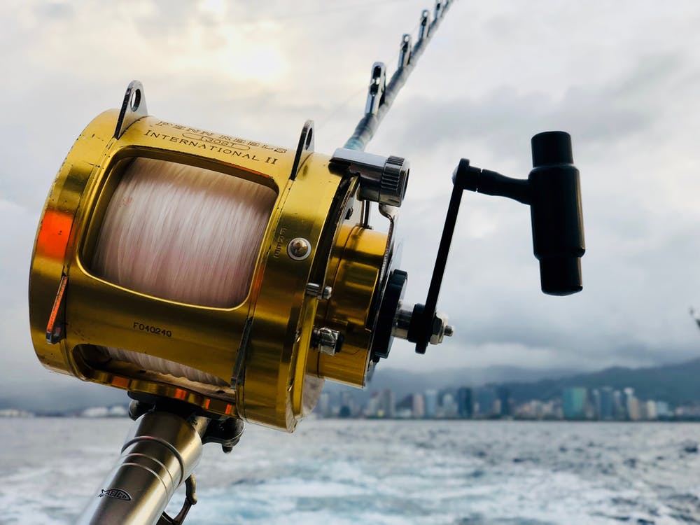 a yellow fishing reel and the sea.