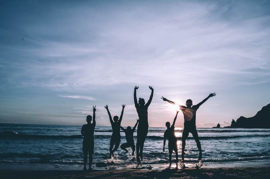 Silhouettes of people at a bachelorette party on a beach