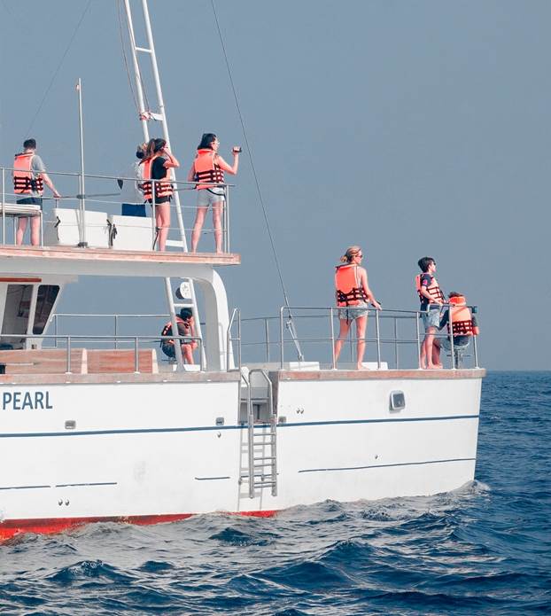 people on a boat wearing lifejackets 