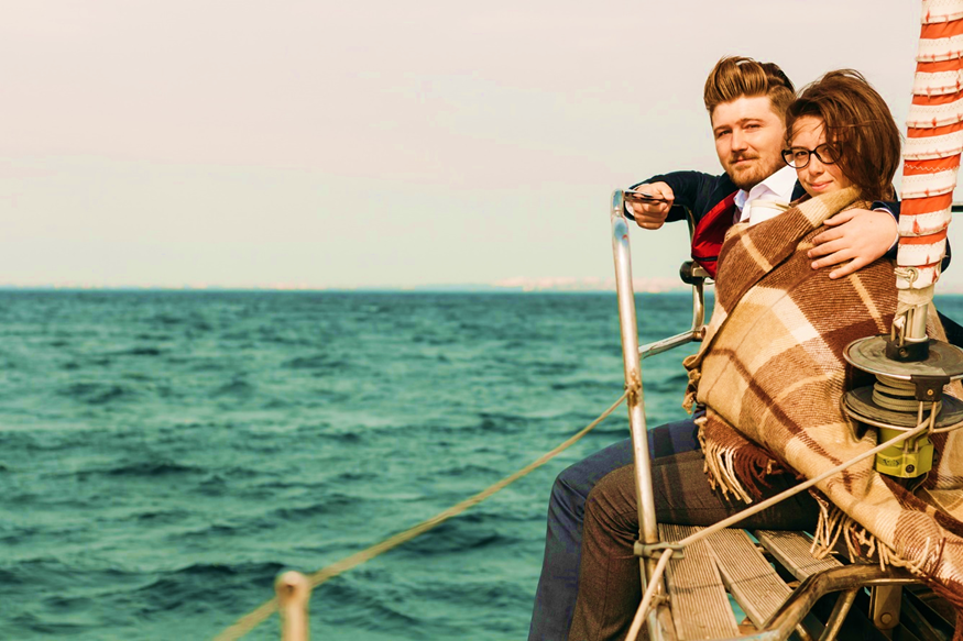 A couple out in the sea on a yacht 